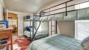 A dormitory room with bunk beds, a wooden dresser, a rug, and a window with blinds. - ~ 3 Mi to Lake Texoma: Kingston Family Retreat (Kingston)