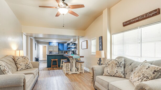 A living room with two sofas, a ceiling fan, and a kitchen in the background. - ~ 3 Mi to Lake Texoma: Kingston Family Retreat (Kingston)