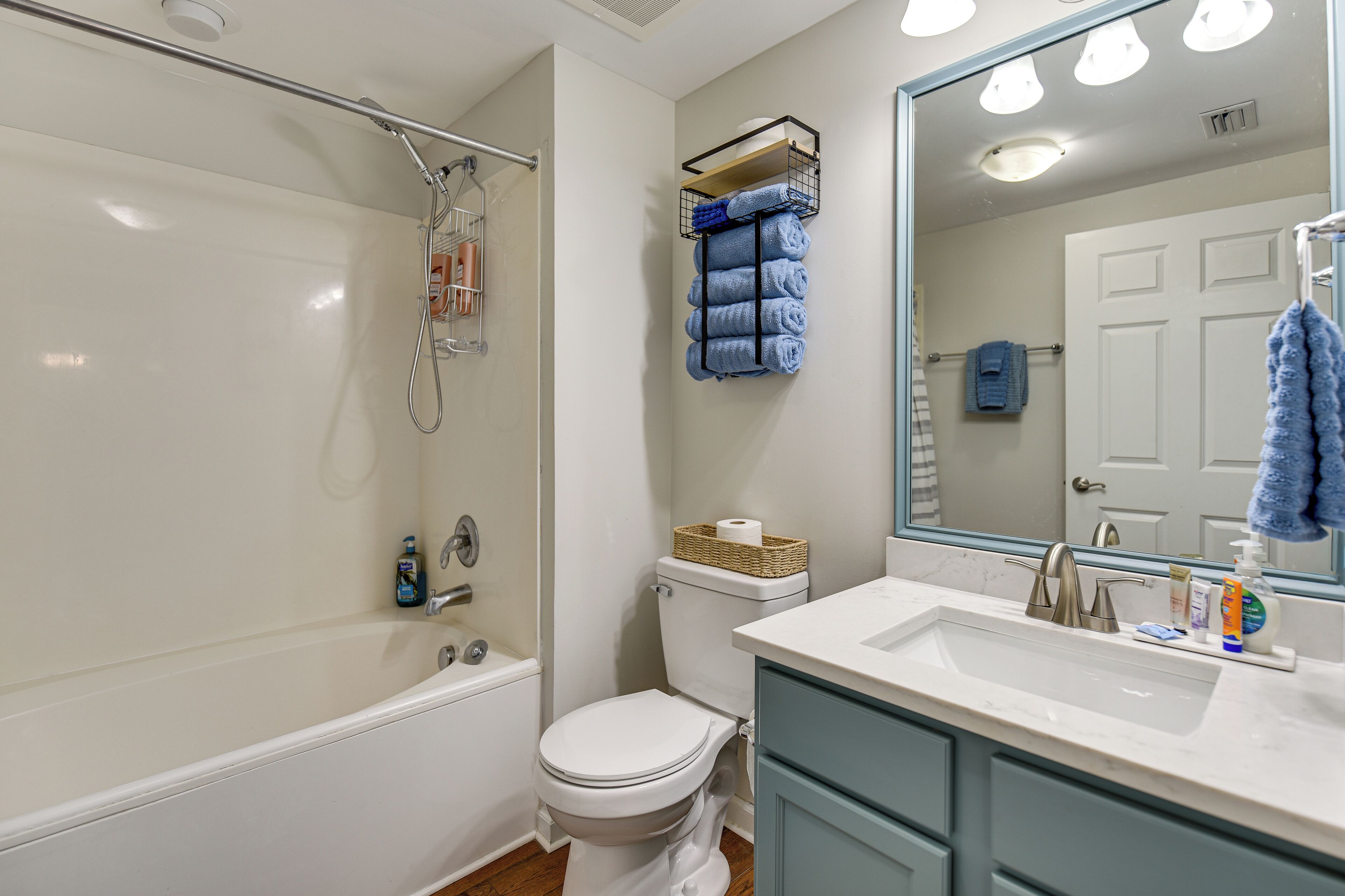 A modern bathroom with a bathtub, toilet, and sink.