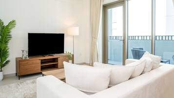 Deluxe Apartment | Living area | 55-inch Smart TV with digital channels