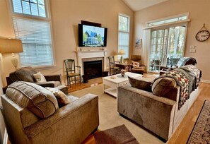 A living room with a fireplace, a television, and a sofa set. - New Listing * Bear Trap Dunes Resort: Beautiful Vacation House (Ocean View)