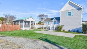 A two-story house with a covered porch and a separate garage.