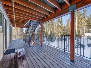 Covered deck with wooden beams overlooking snow-covered landscape and tall evergreens. - Ski-In/Ski-Out on Chair 8 | Cozy Condo Sleeps 6 (Brian Head)