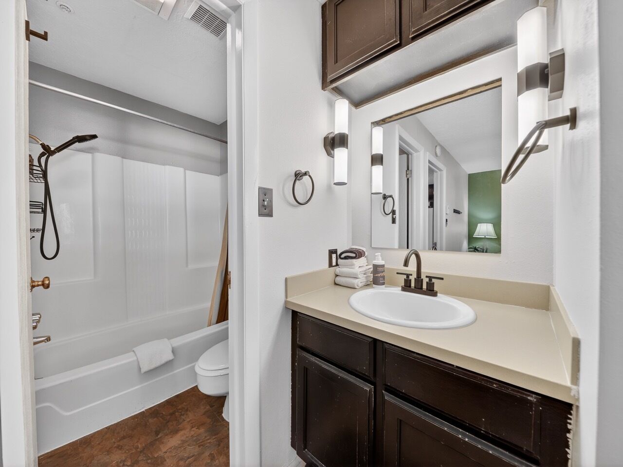 A bathroom with a bathtub, a sink, and a mirror.