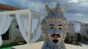 A decorative sculpture with a crown on a table.