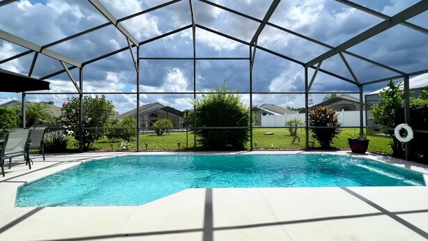 A covered swimming pool with a clear view of the surrounding neighborhood.
