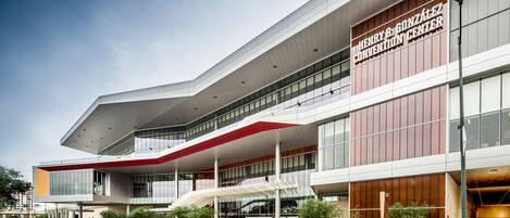 A modern building with a prominent sign reading "Henry B. Gonzalez Convention Center".