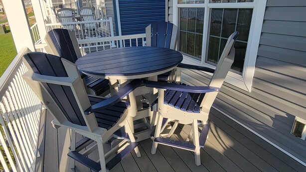 A covered outdoor patio with a round table and six Adirondack chairs. - Waterfront! Amenities! Waterview at Bay Point. (Lakeside Marblehead)