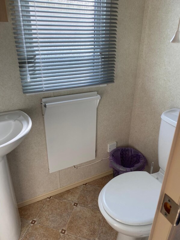 A bathroom with a toilet, bidet, and a radiator. - Beach Haven - Silver Beach - Standard (Skegness)