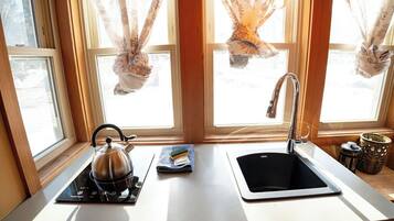 Fridge, stovetop, electric kettle, cookware/dishes/utensils