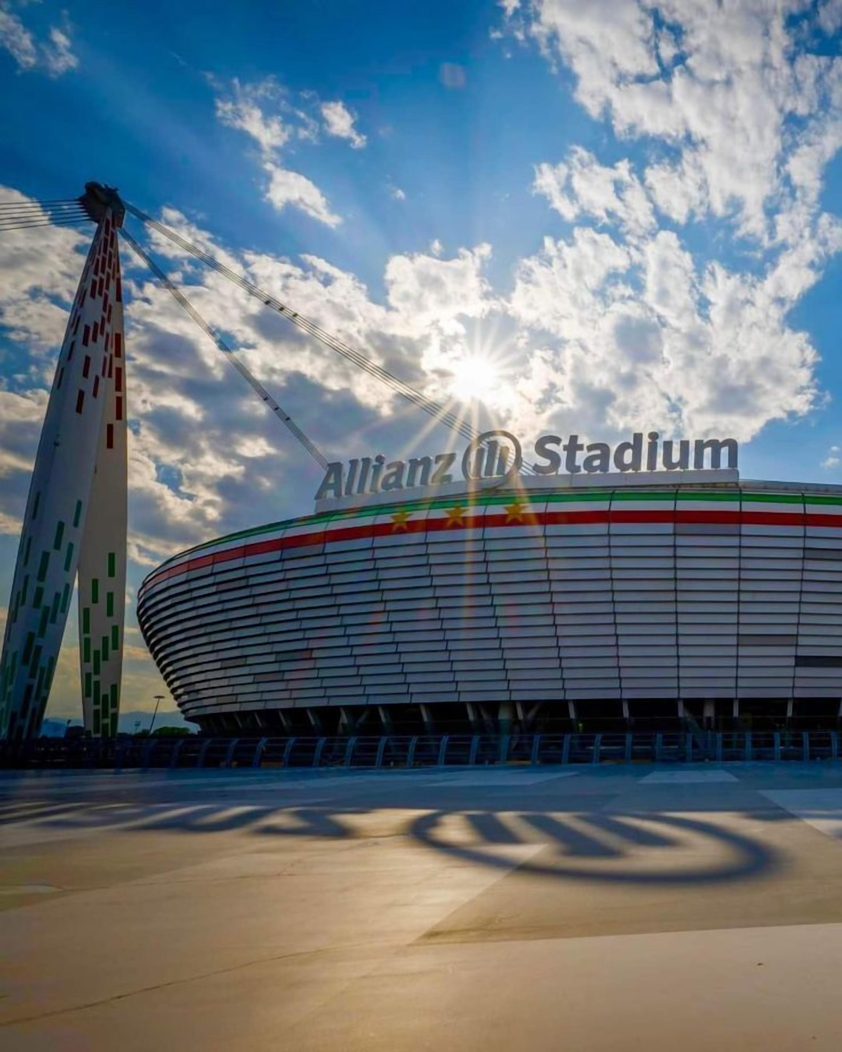 Allianz Stadium with a clear sky and sunlight.