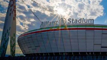 Allianz Stadium with a clear sky and sunlight.