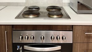 A kitchen with a stainless steel stove, oven, and microwave.