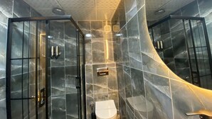 A modern bathroom with a glass shower enclosure, a toilet, and a sink. - Beşiktaş Vip İnn Hotel & Suites (Istanbul)