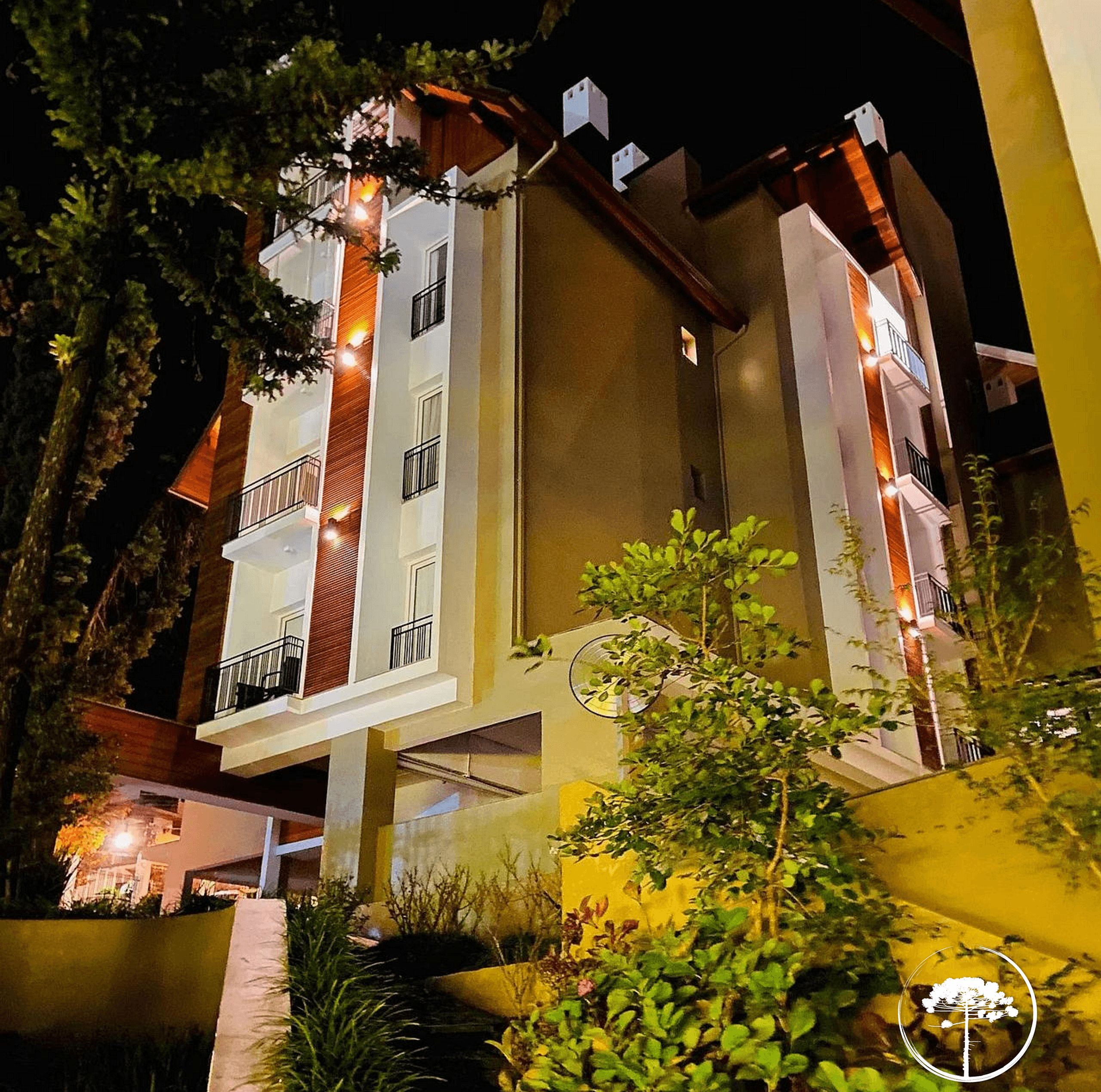 A multi-story hotel with balconies and a well-lit facade.