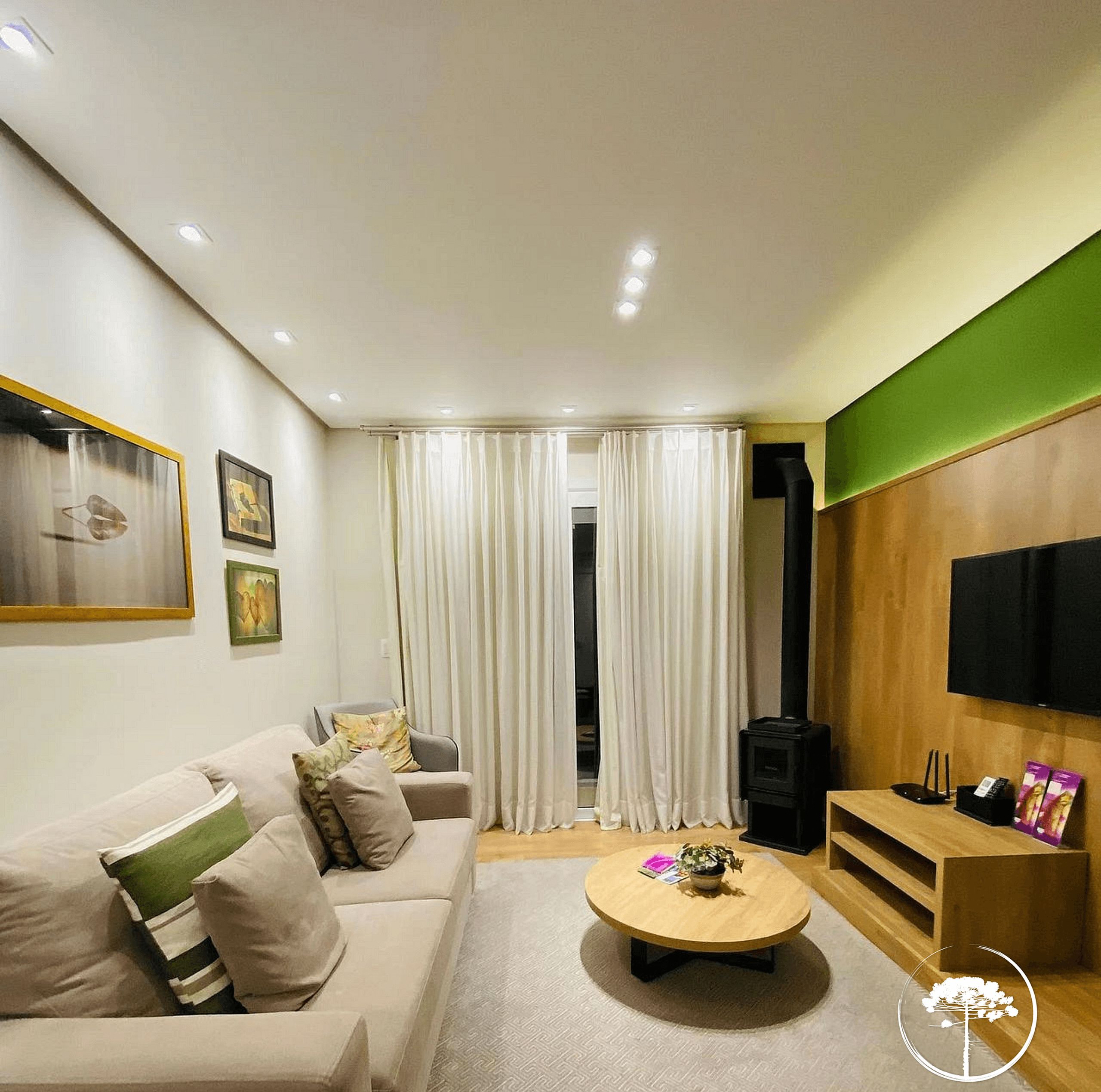 A modern living room with a sofa, a coffee table, and a television.