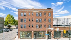 A two-story brick building with a storefront on the ground floor.