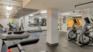 A gym with treadmills, exercise balls, and weight machines.