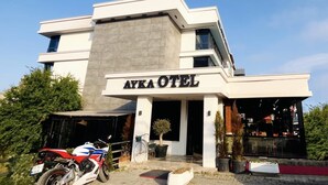 A modern hotel named "AYKA HOTEL" with a two-story structure, a covered entrance, and a visible outdoor seating area. - ATAKUM AYKA OTEL (Atakum)