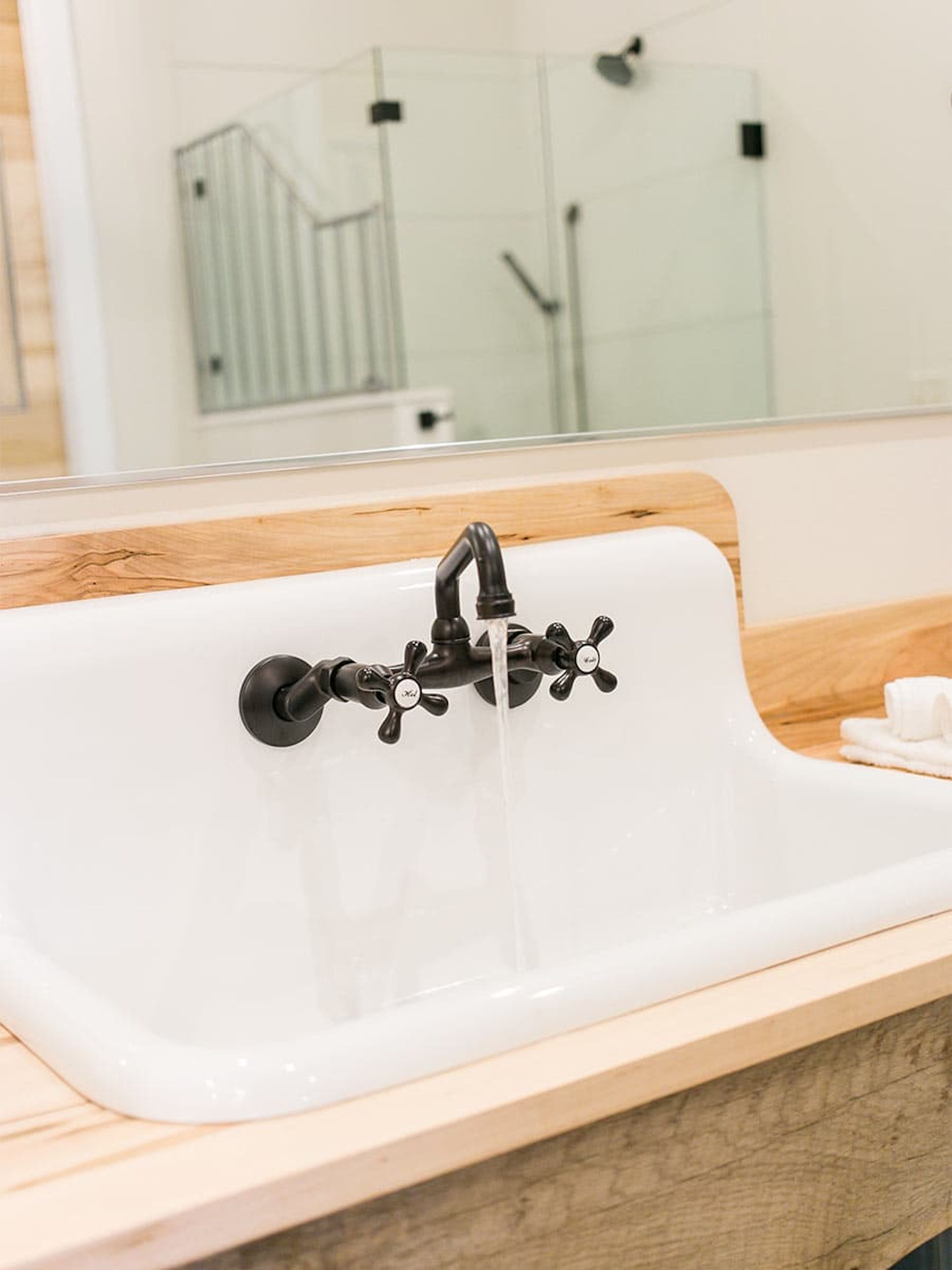 A bathroom sink with a modern faucet and a mirror above it.