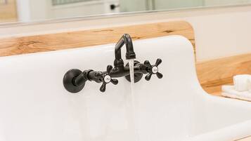 A bathroom sink with a modern faucet and a mirror above it.