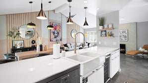 A modern kitchen with a central island, pendant lighting, and a built-in dishwasher. - 'Miles Away' A Desert Oasis - Palm Springs Style! (Palm Springs)