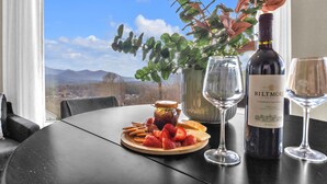 A table with a bottle of Biltmore wine, two glasses, a plate with strawberries and cheese, and a jar of jam. - 7br Asheville Mansion, Views, Pool, Full Spa, Hot Tub, Gameroom - close to DownT (Asheville)
