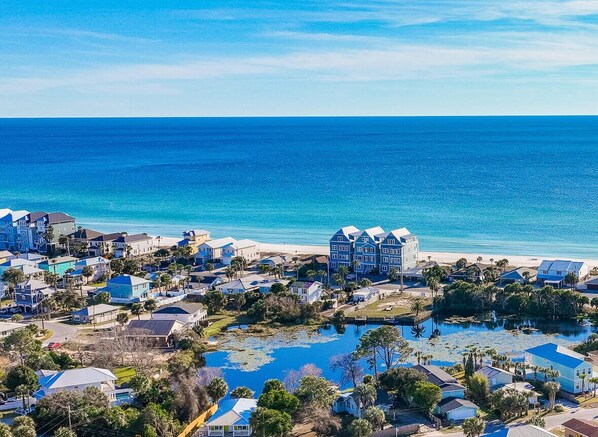 A coastal residential area with houses and a beach.