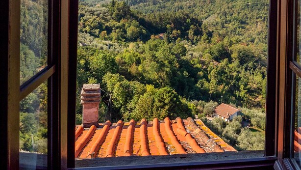 A view from a window overlooking a valley with terraced fields and a distant mountain range. - AramoVerde
Tuscan house in the heart of green hills in a medieval village (Aramo)
