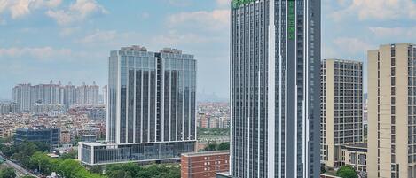 A high-rise hotel with a modern design, featuring multiple floors and a prominent logo on the facade.