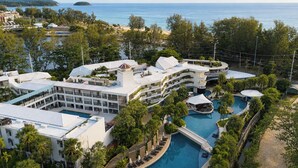 A resort with multiple buildings, a central pool, and a view of the sea. - Holiday Inn Resort Phuket Karon Beach by IHG (Karon)