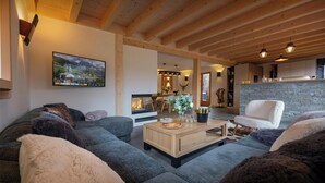 Un soggiorno accogliente con camino, zona pranzo e cucina con rivestimento in pietra.