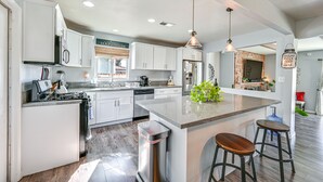 A modern kitchen with white cabinets, a granite countertop, and stainless steel appliances. - Walkable Chula Vista Home w/ Covered Patio (Chula Vista)
