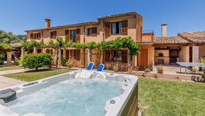 A two-story house with a swimming pool, outdoor seating, and a barbecue area. - Beautiful house with views to the mountains near Pollensa (Pollensa / Pollença)