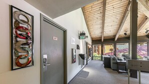 A hallway with a door marked 217, a wall-mounted security keypad, and a sign indicating a cafe. - Studio w/Kitchen 2nd Floor #217 at Donner Lake Village (Truckee)