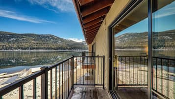 A balcony with a view of a lake and mountains.