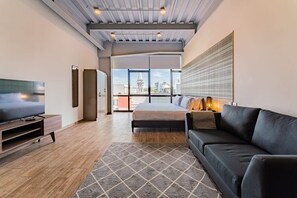 Relax in a spacious room with a large bed, flat-screen TV, and city views.