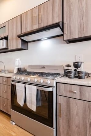 Enjoy cooking in this well-equipped kitchen with a stainless steel stove, oven, and coffee maker.