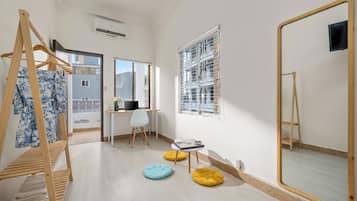 Family Triple Room | Living area | 45-inch TV with cable channels