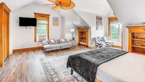A spacious room with a large bed, a ceiling fan, a sofa, and a TV mounted on the wall. - ☆New! Central+FreeParkin+GYM+Kingbed (Pittsburgh)