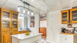 A kitchen with wooden cabinets, a white island, and a coffee station. - ☆New! Central+FreeParkin+GYM+Kingbed (Pittsburgh)