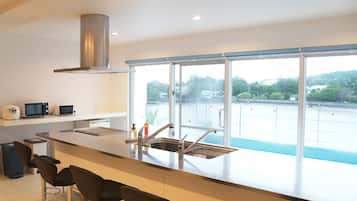 Deluxe Room | Private kitchen | Full-sized fridge, microwave, stovetop, toaster