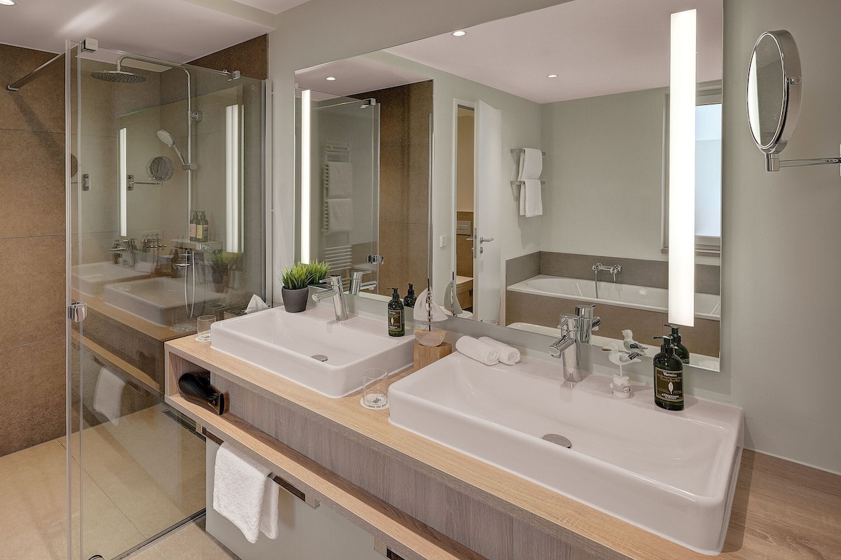Sandburg Suite | Bathroom | Designer toiletries, hair dryer, bathrobes, slippers