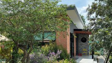 A modern building with a brick facade, a stone accent wall, and a glass door entrance.