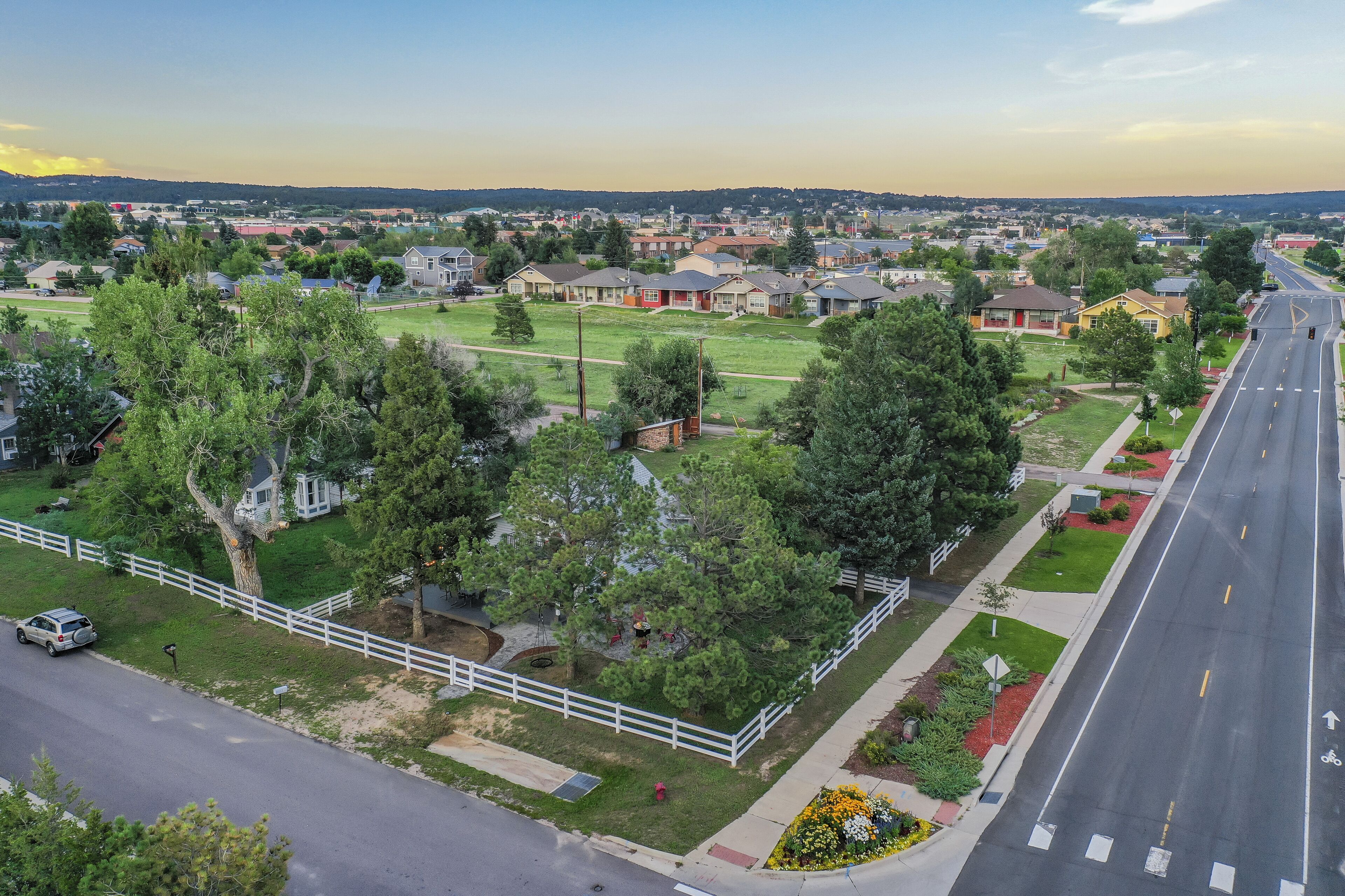 A residential area with houses, a road, and a park.