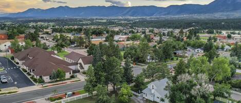 A residential area with houses, roads, and mountains in the background.
