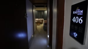 A hallway with a digital display indicating room number 406 at Eastin Hotels. - Eastin Hotels (Hyderabad)