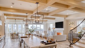 A spacious kitchen with a large island, wooden beams, and a fireplace. - Sleeps 24, Elevator, Private Beach Boardwalk, Infinity Pool | 20 Bradley Circle (Hilton Head Island)