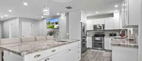 Fridge, stovetop, coffee/tea maker, cookware/dishes/utensils