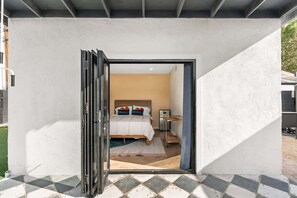 Une chambre à coucher avec un lit, des tables de chevet et une commode.